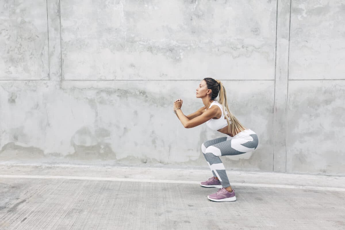 woman doing squats as part of her 5-minute lower body workouts