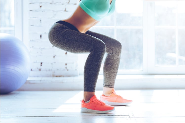 Woman doing squats as part of a Do This Squat Challenge to Get Your Booty Firm and Round
